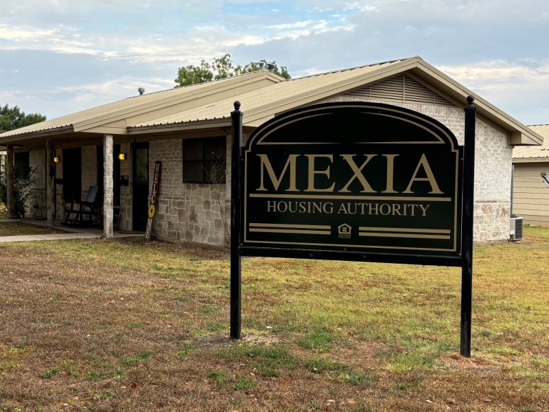 Picture of a tan house from the road